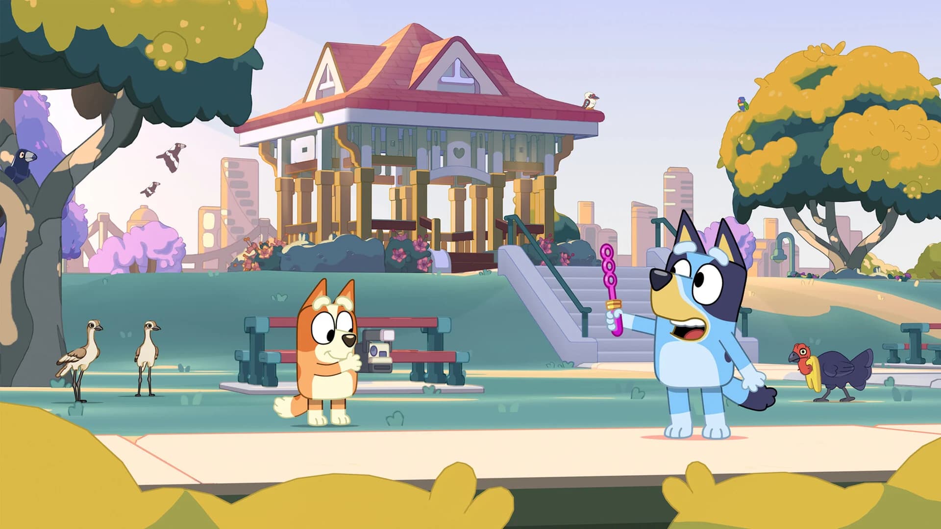 Bluey and Bingo explore a sunny park in Bluey’s Happy Snaps.